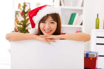 Christmas woman leaning over billboard sign