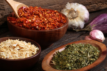 Various spices over a wood background.