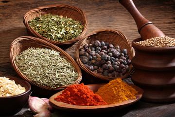 Different spices over a wood background.