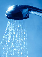 Obraz na płótnie Canvas shower water flows drops on a blue background