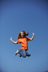 Young Girl Jumpingon a sunny day