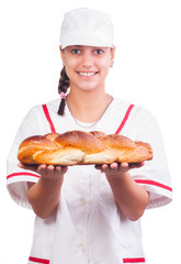 Happy female baker in white uniform and cap
