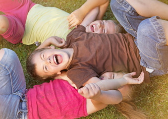 Portrait of childrens posing on grass and smiling