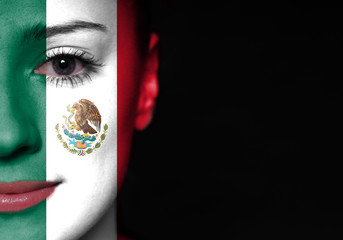 Painted woman face with flag of Mexico