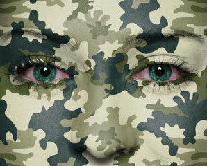 Camouflage painted on woman a face - obrazy, fototapety, plakaty