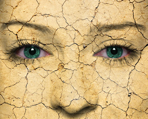 Woman face covered with old cracked red paint