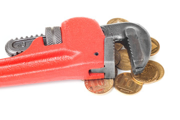 Monkey wrench on a big heap of gold coins