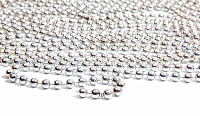 Silver beads on white background