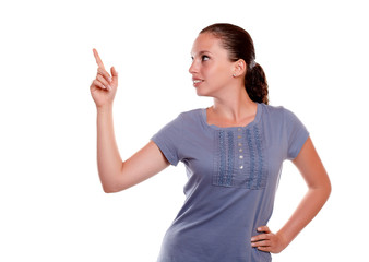 Charming young isolated woman pointing up