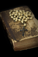 Ancient book with prayer beads