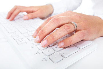 Hands with a computer keyboard.
