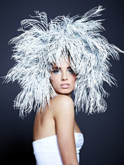 Young woman in creative image with silver artistic make-up.