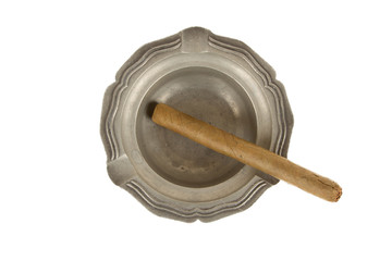 Unused large cigar in an old tin ashtray