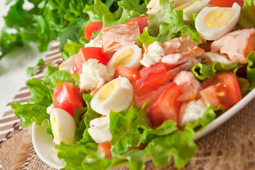 fresh salmon salad, lettuce and quail eggs