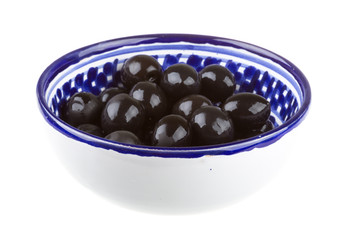 Olives black watered with olive oil in a bowl isolated on a whit