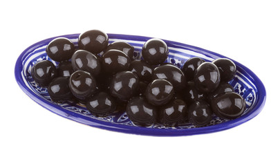 Olives black watered with olive oil in a bowl isolated on a whit