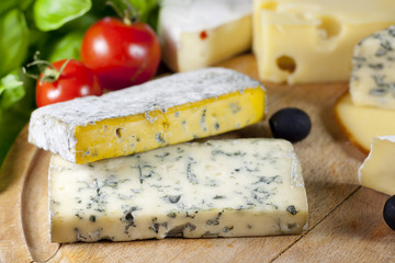 Cheese on cutting board closeup various assortment