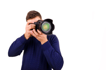 Young photographer with camera on white background