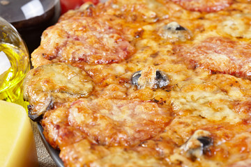 Italian cuisine. Pizza with salami, pickles and olives