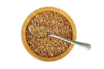 wood bowl with buckwheat and steel spoon with lentil