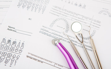 Dental tools and equipment on dental chart