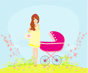 beautiful pregnant woman pushing a stroller