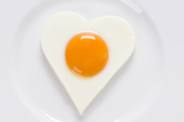 heart shaped cooked egg on a plate