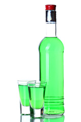 bottle and two glasses of absinthe isolated on white