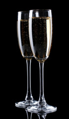 two glasses of champagne on black background