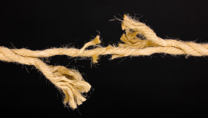 Breaking rope isolated on black
