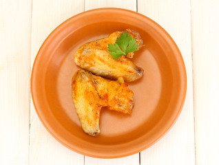 roasted chicken wings with parsley in the plate