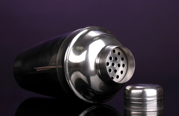 Cocktail shaker on violet background