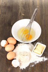 Eggs, flour and butter close-up on wooden table