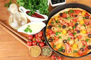 colorful composition of delicious pizza, vegetables and spices