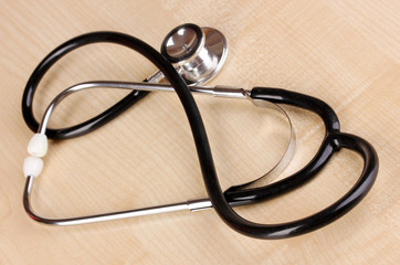 Stethoscope on white wooden table