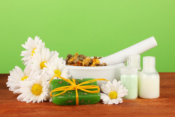 ingredients for soap making on green background