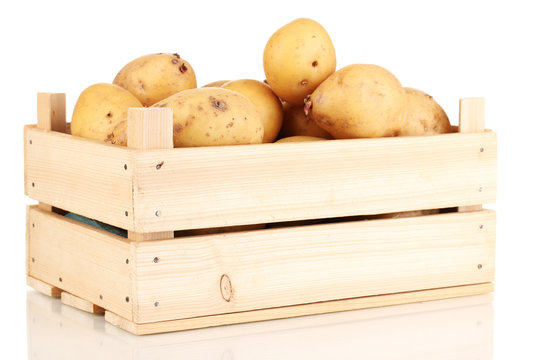 Ripe potatoes on wooden box isolated on white