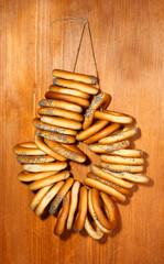 tasty bagels on rope, on wooden background