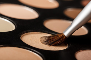 Close-up of eyeshadow palette with brush