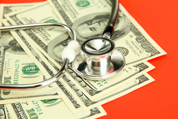 Healthcare cost concept: stethoscope and dollars