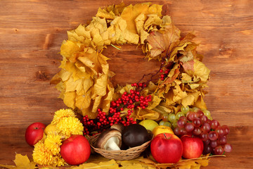 Autumnal composition with yellow leaves, apples and mushrooms