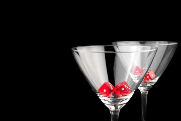 red dice in two cocktail glasses