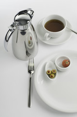 Breakfast table with thermos cup and tomato and olive