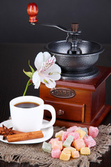 Cup of coffee with rahat delight and coffee mill on wooden