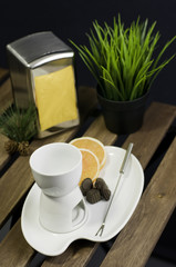 China fondue set and orange slice on wooden table
