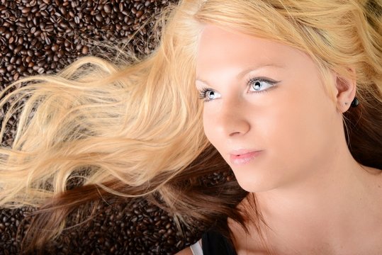 beautiful young woman with coffee beans