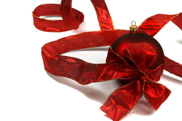 red christmas bauble with ribbon and bauble on white