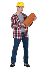 Tradesman holding shingles