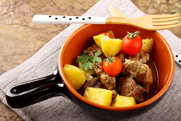 Meat stew with boiled potatoes and tomato