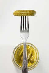 Pickled gherkin on a fork